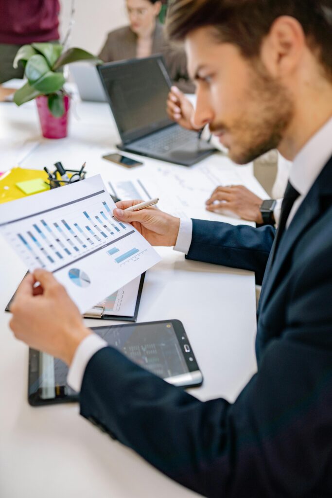 Professionista del marketing immobiliare analizza un report con grafici per ottimizzare le campagne